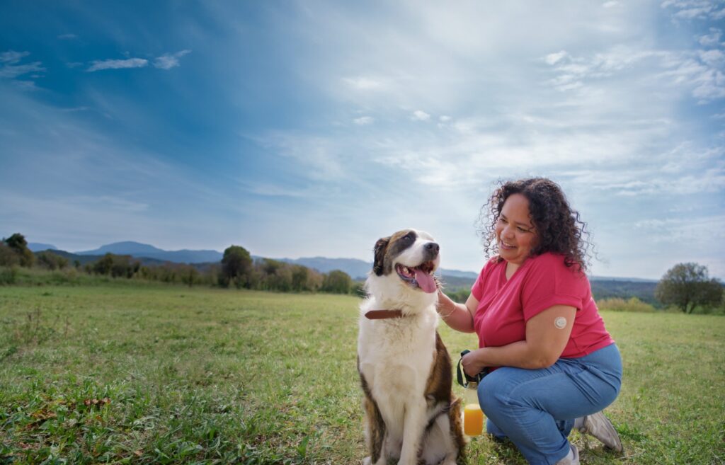 Person wearing a continuous glucose monitor using diabetes technology